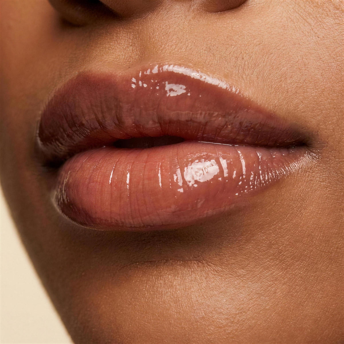 Ruby Claire Dream Lip Oil in Warm Beige — closeup on the lips