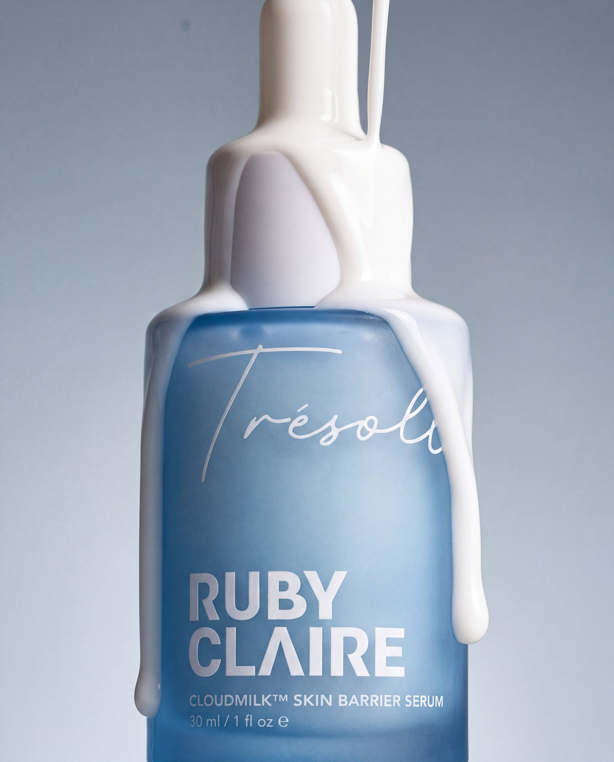 Ruby Claire CloudMilk Serum bottle with milk pouring over the dropper cap