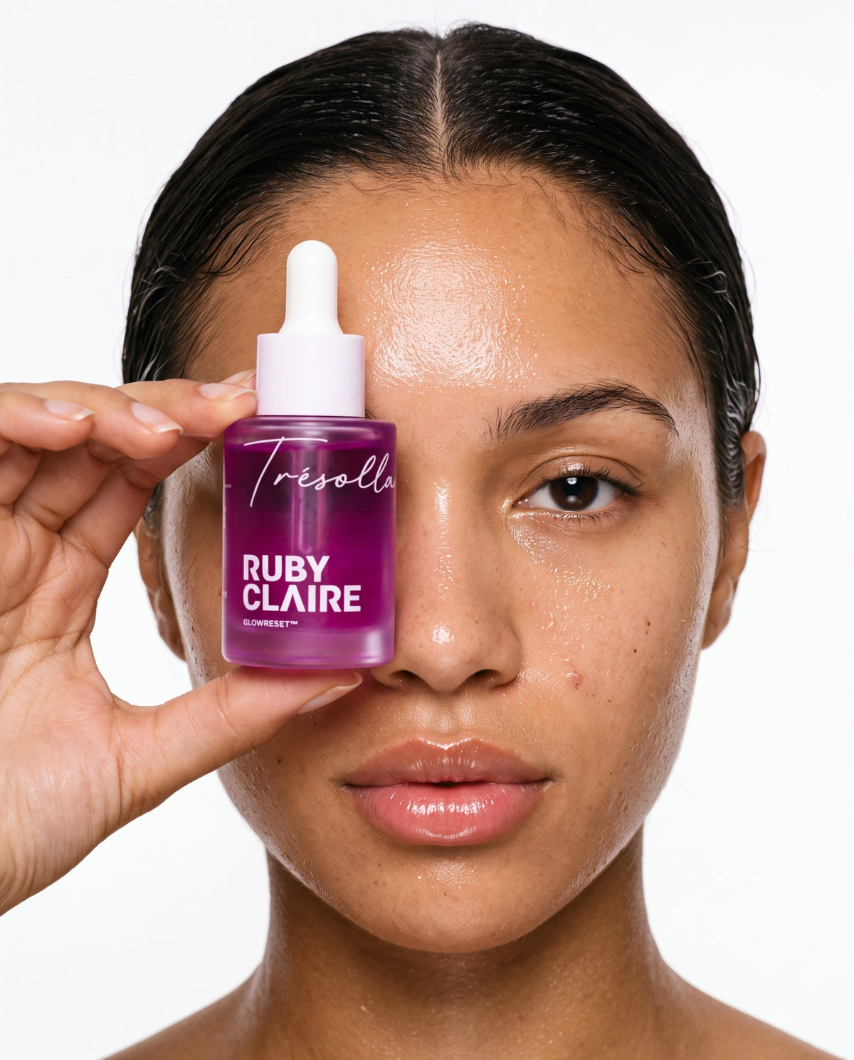 Model holding Ruby Claire GlowReset in front of her eye