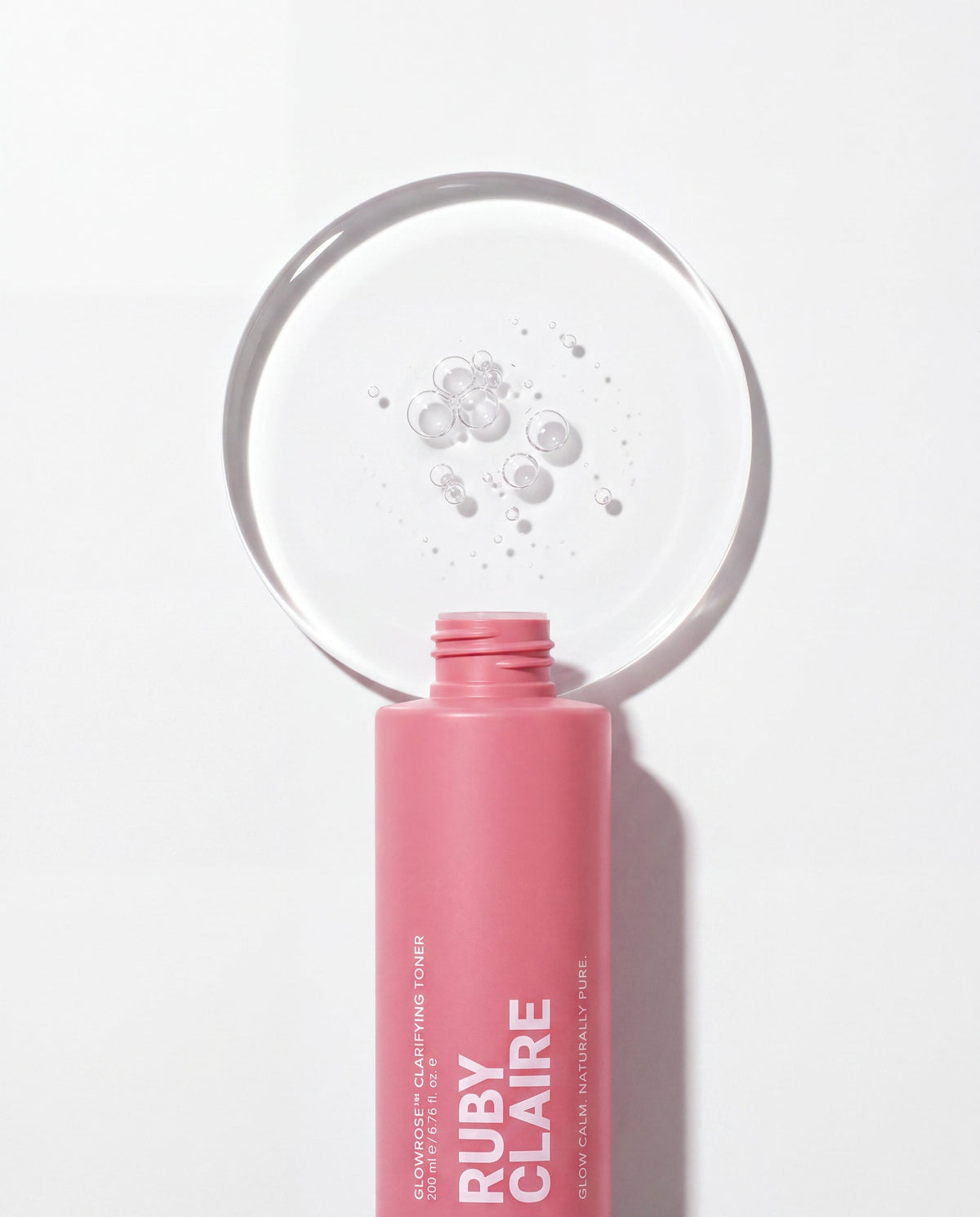 Ruby Claire GlowRose Clarifying Toner texture disc above the open bottle