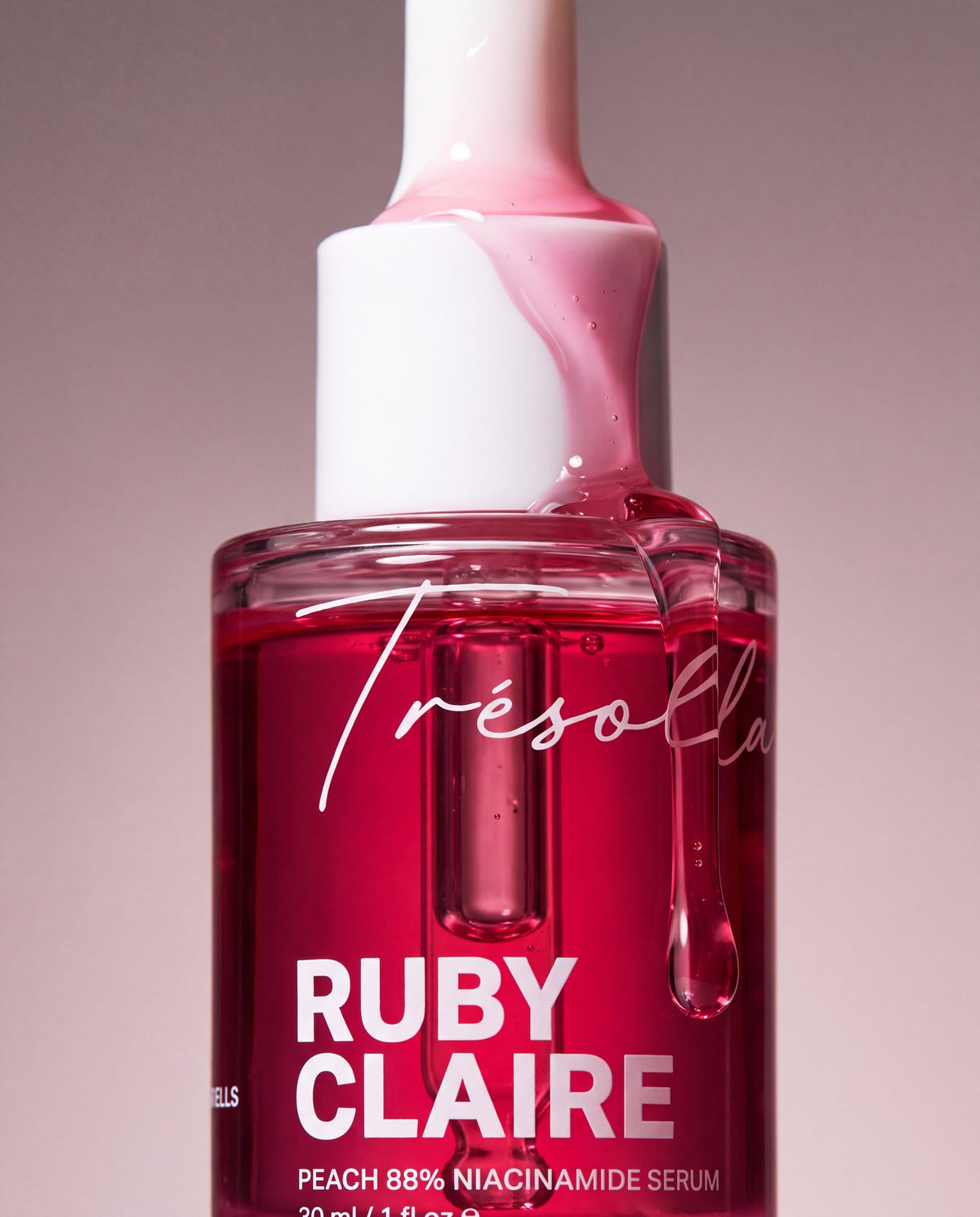 Ruby Claire Peach Niacinamide Serum bottle with pink serum running over the cap