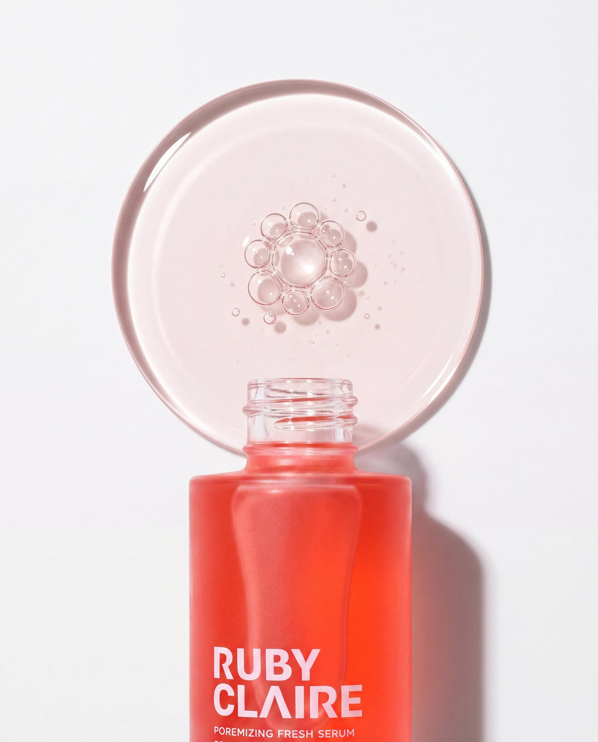 Ruby Claire Poremizing Fresh Serum texture disc above the open bottle