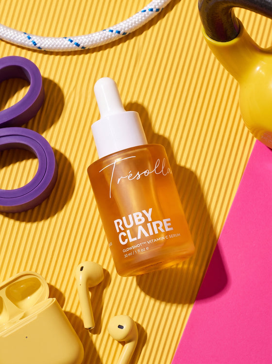 Ruby Claire GlowShot Vitamin C Serum in a gym flat lay
