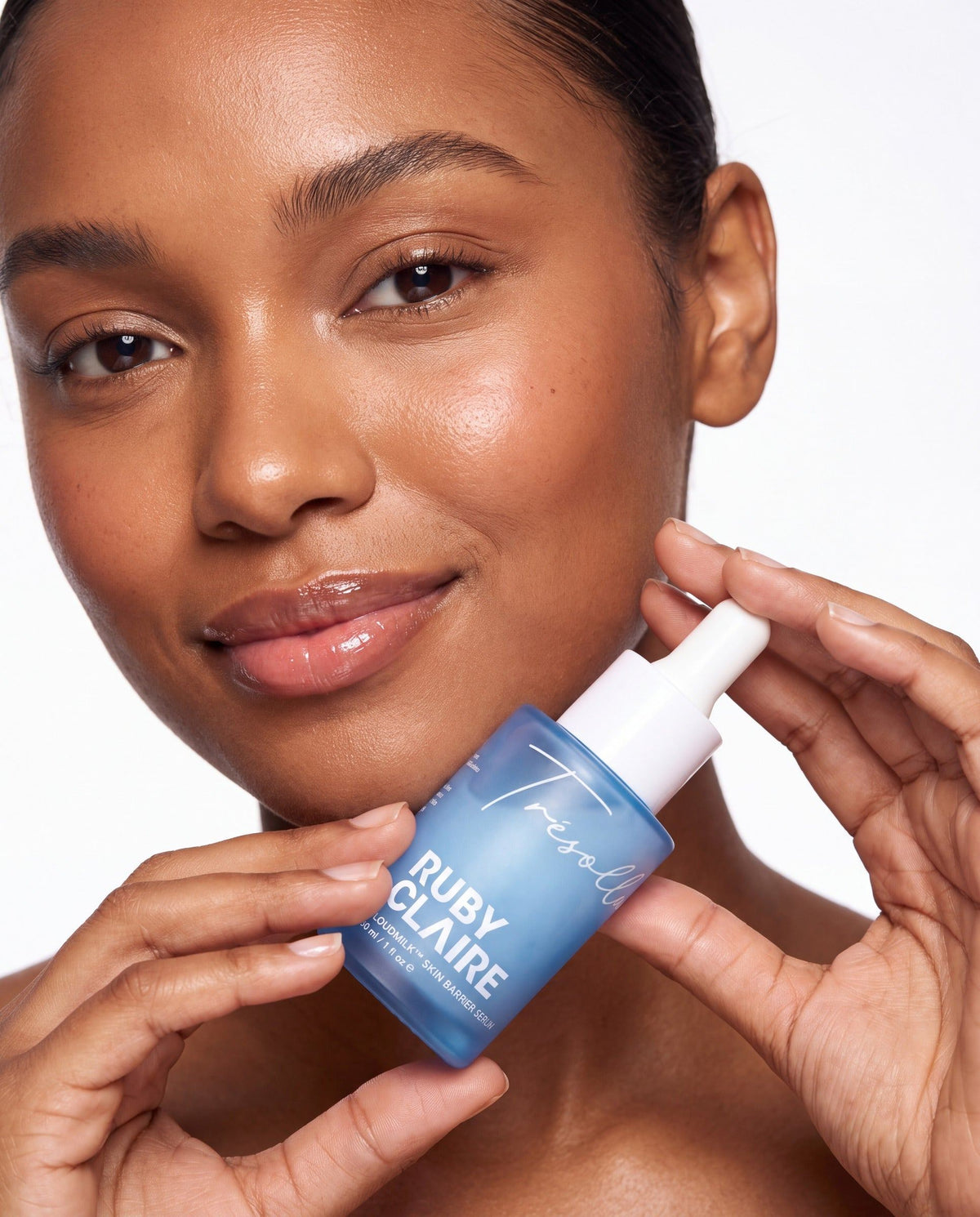 Model holding Ruby Claire CloudMilk Serum in lab coat